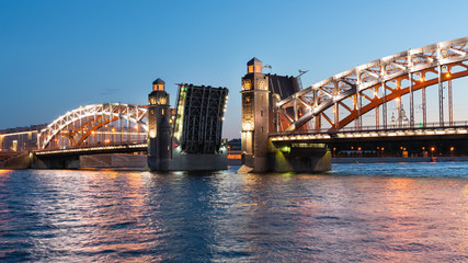 Bolsheokhtinsky bridge in St. Petersburg at night with open spans over the Neva.