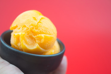 Delicious ice-cream mango passion fruit in hand