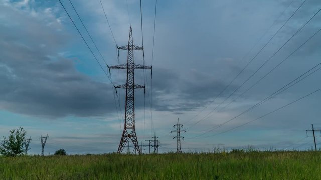 Electricity pylons and beautiful clouds. Timelapse. 4K