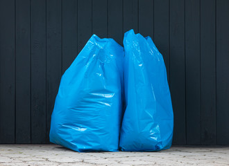 plastic blue trash bag in the street