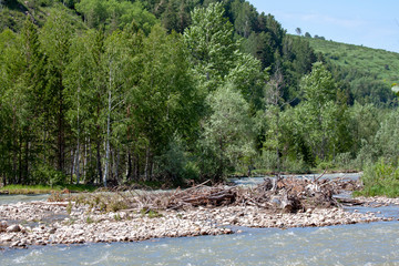 Mountain river surrounded by wooded slopes.