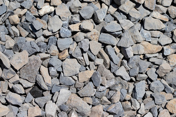 The texture of stone gravel gray. Stone rubble gray poured pile close-up. Stone path crushed stone.