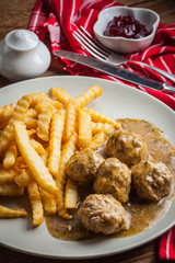 Meatballs with french fries in dill sauce.