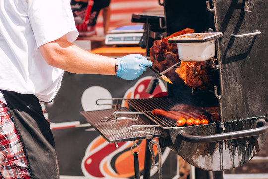 pork grill (mooping) is pork is grill with oil on a brazier in the street in the summer.The men doing pork grill.