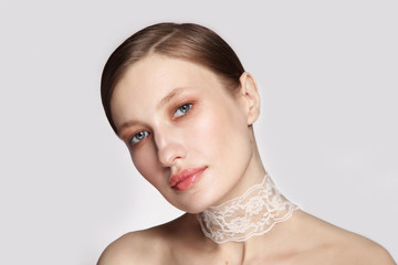 Vintage style portrait of young beautiful woman with clean glowing makeup