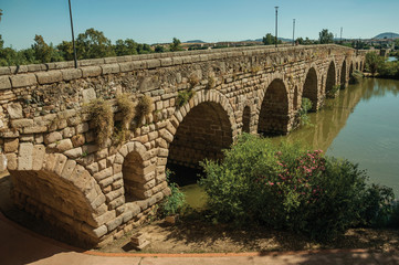 Fototapeta premium The ancient long bridge still in use over the Guadiana River at Merida