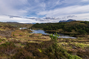 Fototapeta na wymiar Loch Duartmore, Assynt, Sutherland, Scottish Highlands, with Quinag jin the distance. Part of the scenery of the North Coast 500 route.