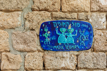 Jaffa, Israel - Dec 22, 2018: Road sign with zodiac sign of the twins in Jaffa