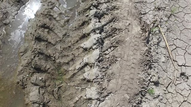 Tire track print in the mud and dirt after wheel earth mover or bulldozer construction digger machinery finish with work in the city street, with movement forward 
