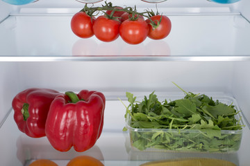 Open fridge full of fresh fruits and vegetables