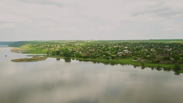 Flying over the river on a sunny summer day. Dniester river of Moldova republic.