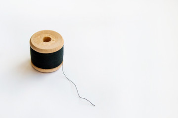 Multicolored thread coils on pink blue background. Sewing supplies and accessories for needlework,...