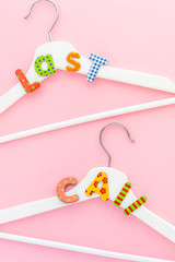 White hangers with sale text on pink background