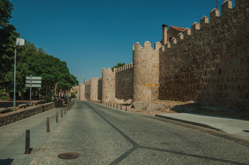 Pedestrian promenade beside large city wall at Avila
