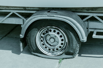 Flat tire. Punctured wheel. Trailer with a punched and flat tire