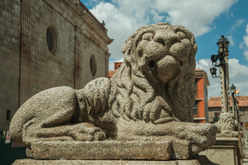Sculpture of a sitting lion carved in stone at Avila