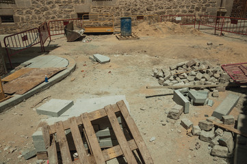 Piles of stones and rubble in a construction site at Avila