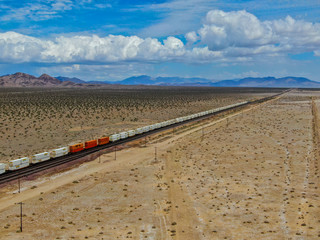 Cargo locomotive railroad engine crossing Arizona desert wilderness. Freight train passing by the desert. USA