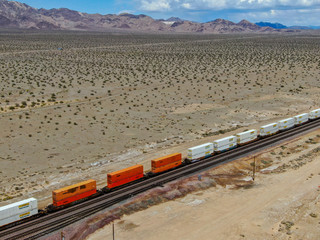 Cargo locomotive railroad engine crossing Arizona desert wilderness. Freight train passing by the...