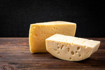 Cheese on dark wooden background