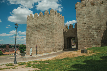 Fototapeta na wymiar Road at the Carmen Gateway in the stone city wall of Avila