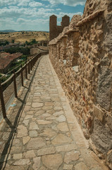 Fototapeta na wymiar Pathway over old thick wall encircling the town of Avila