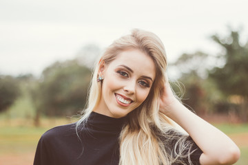 Naklejka premium Portrait of a beautiful young woman. She is looking at the camera and smiling happily. People, facial expressions and positive emotions. Lifestyle. Photo of Brazil