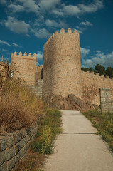 Fototapeta na wymiar Pathway and stone towers in the large wall of Avila