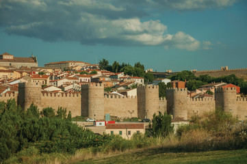 Fototapeta na wymiar Towers with large wall over the hill encircling the Avila