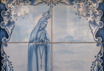A painted tile artwork with image of Virgin Mary