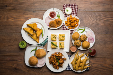 Indian Tea time snacks  in group includes Veg Samosa, Kachori/kachaudi, aloo bonda, khaman dhokla,...