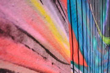 Detail of an anonymous street graffiti with many colors, cheerful urban background.