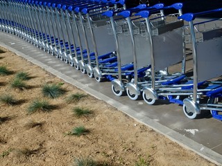 baggage or luggage carts at an airport in a row