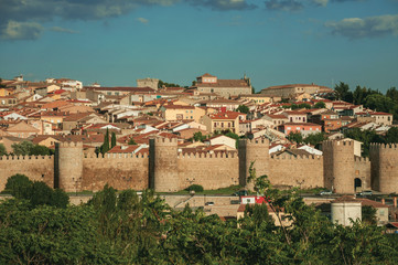 Fototapeta na wymiar Stone towers on large wall over the hill encircling Avila