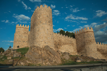 Fototapeta na wymiar Stone tower in a large wall over rocky landscape in Avila