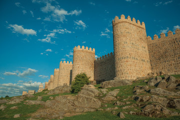 Stone towers over rocky landscape encircling the town of Avila