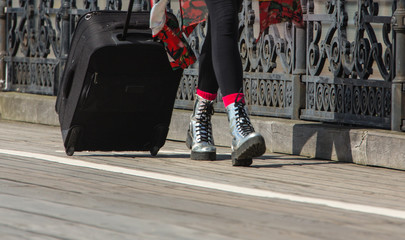 These boots are made for walking: travelling with suitcase on wheels