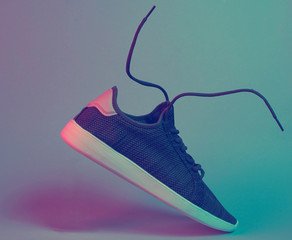 Sport sneakers with flying laces, retro futurism red blue neon light, minimalism