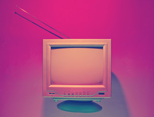 Retro wave, 80s concept. Old tv with antenna, neon light. Night television. Top view, flat lay