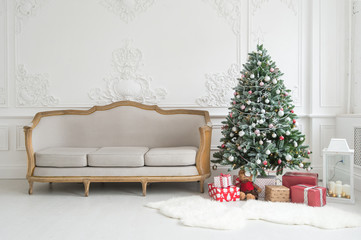 Luxury bright Baroque interior with vintage sofa and Christmas tree.