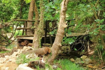 Closeup of deformed and dilapidated wooden bridge on Crete, Greece