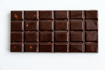 top view of a rectangular tile of classic dark chocolate with divisions into small rectangles for easy eating