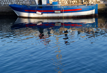 Fototapeta na wymiar reflection of colorful fishing boat
