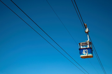Cable car gondola passing through clear blue sky in Madrid