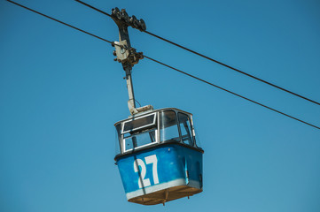Fototapeta na wymiar Cable car gondola passing through clear blue sky in Madrid