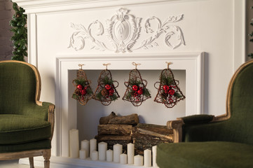 White fireplace with stucco patterns. Christmas decor. Close up. Selective focus.