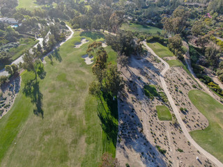Fototapeta na wymiar Aerial top view of a green golf course during sunny day. South California.
