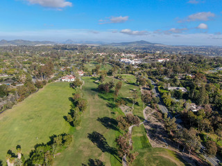 Fototapeta na wymiar Aerial view of a beautiful wealthy green golf course next the valley. San Diego, California. USA. 