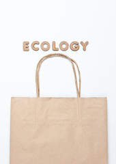 Paper bag on a white background with the word Ecology. Top view