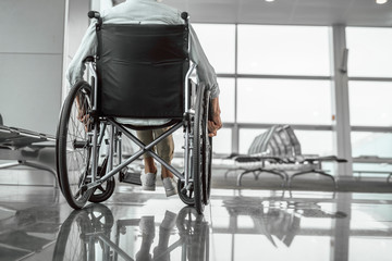 Elderly woman is using a wheelchair in airport